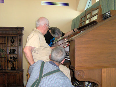 Click here to download a 2048 x 1536 JPG image of Doctor Morrell, Tom Hoehn and the Bone Doctor looking over the organ to make sure everything is go.